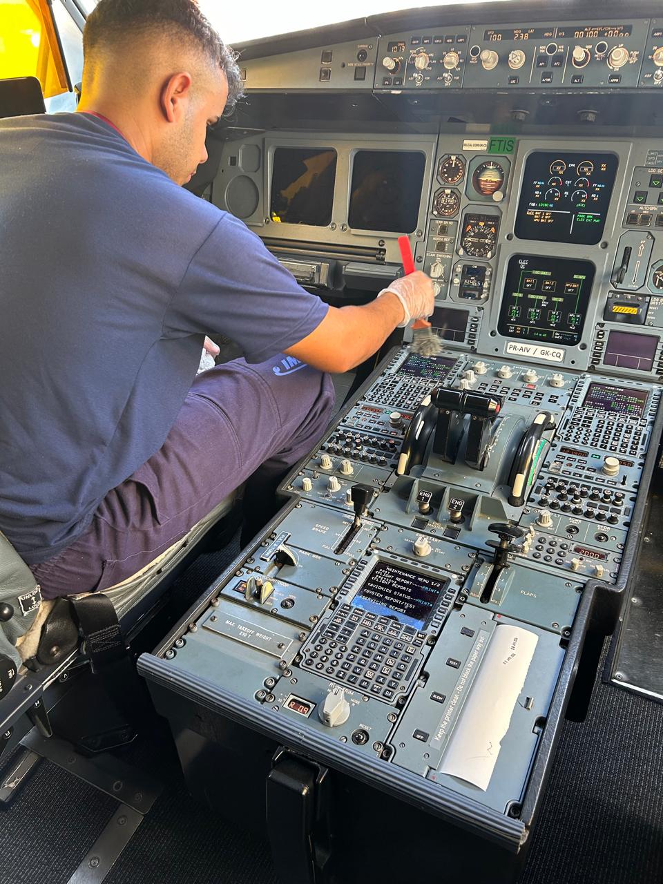 Technician sanitizing the cockpit panel