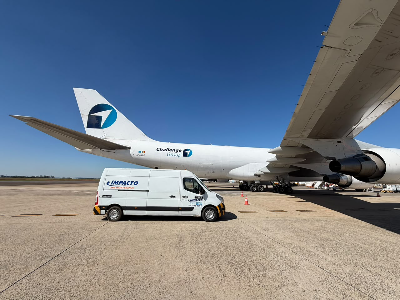 Impacto Aviation line maintenance vehicle next to a Challenge Group aircraft