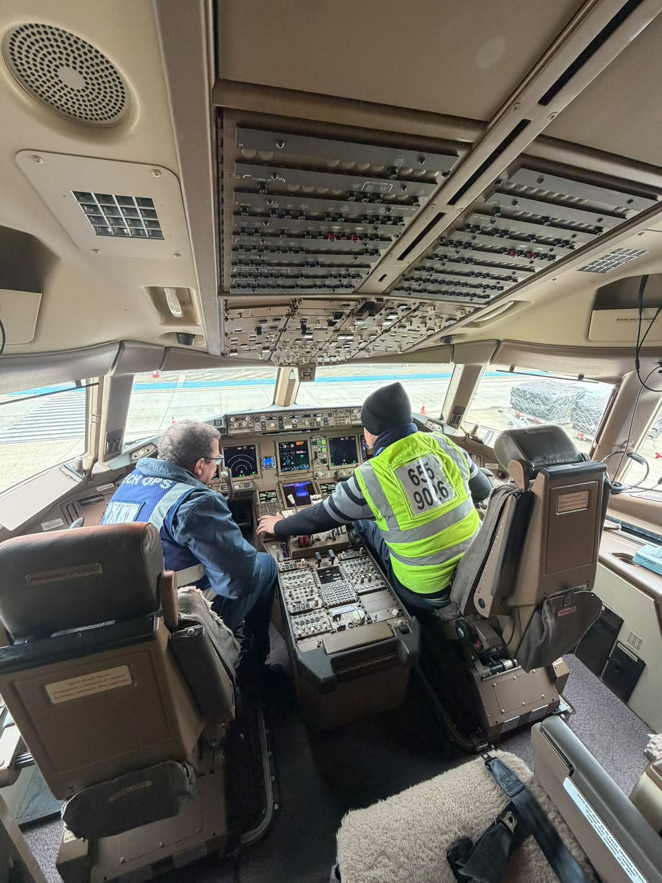 Technicians performing a detailed cockpit inspection