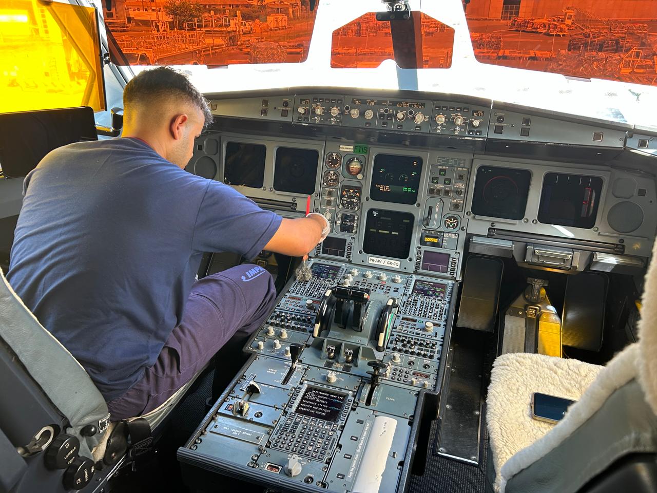 Impacto Aviation technician performing maintenance in an aircraft cockpit