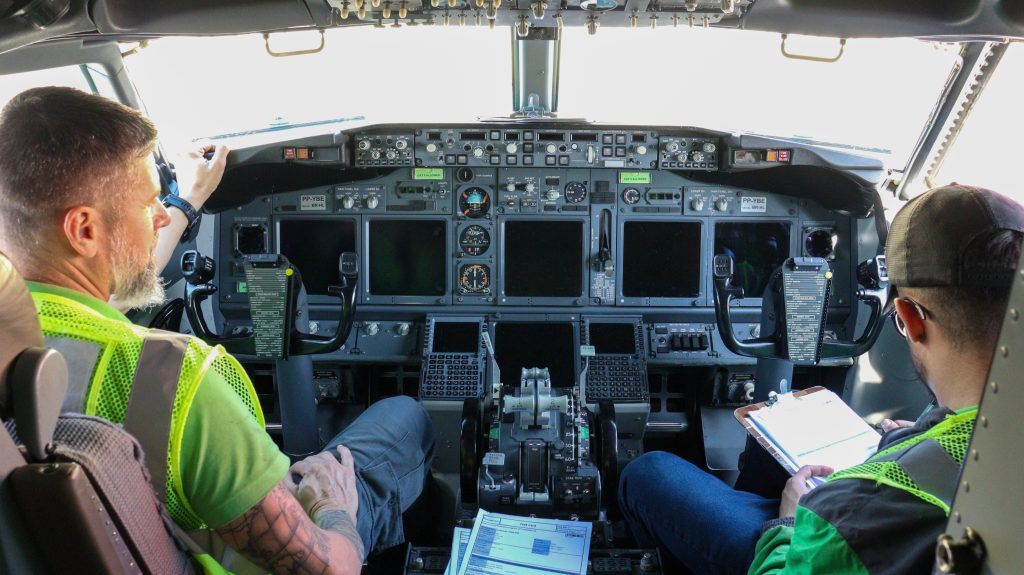 Technicians inspecting the aircraft cockpit